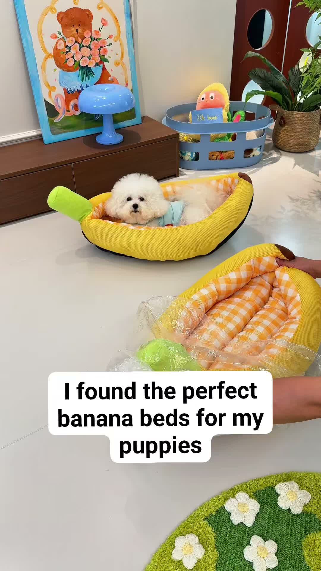 Small white fluffy dog lounging in a banana-shaped yellow pet bed